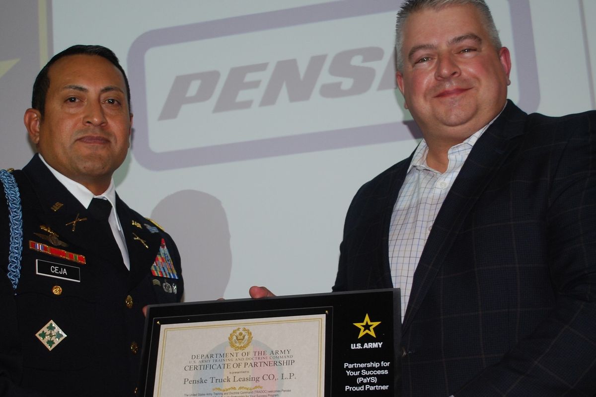 Two men holding a plaque.