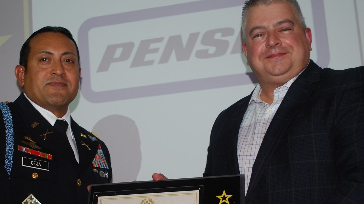 Two men holding a plaque.