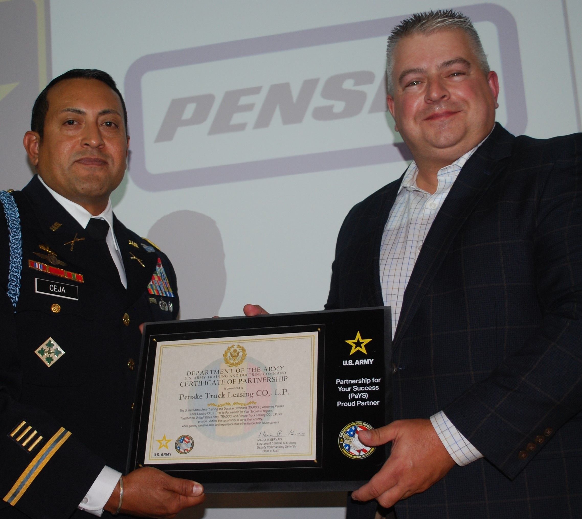 Two men holding a plaque.